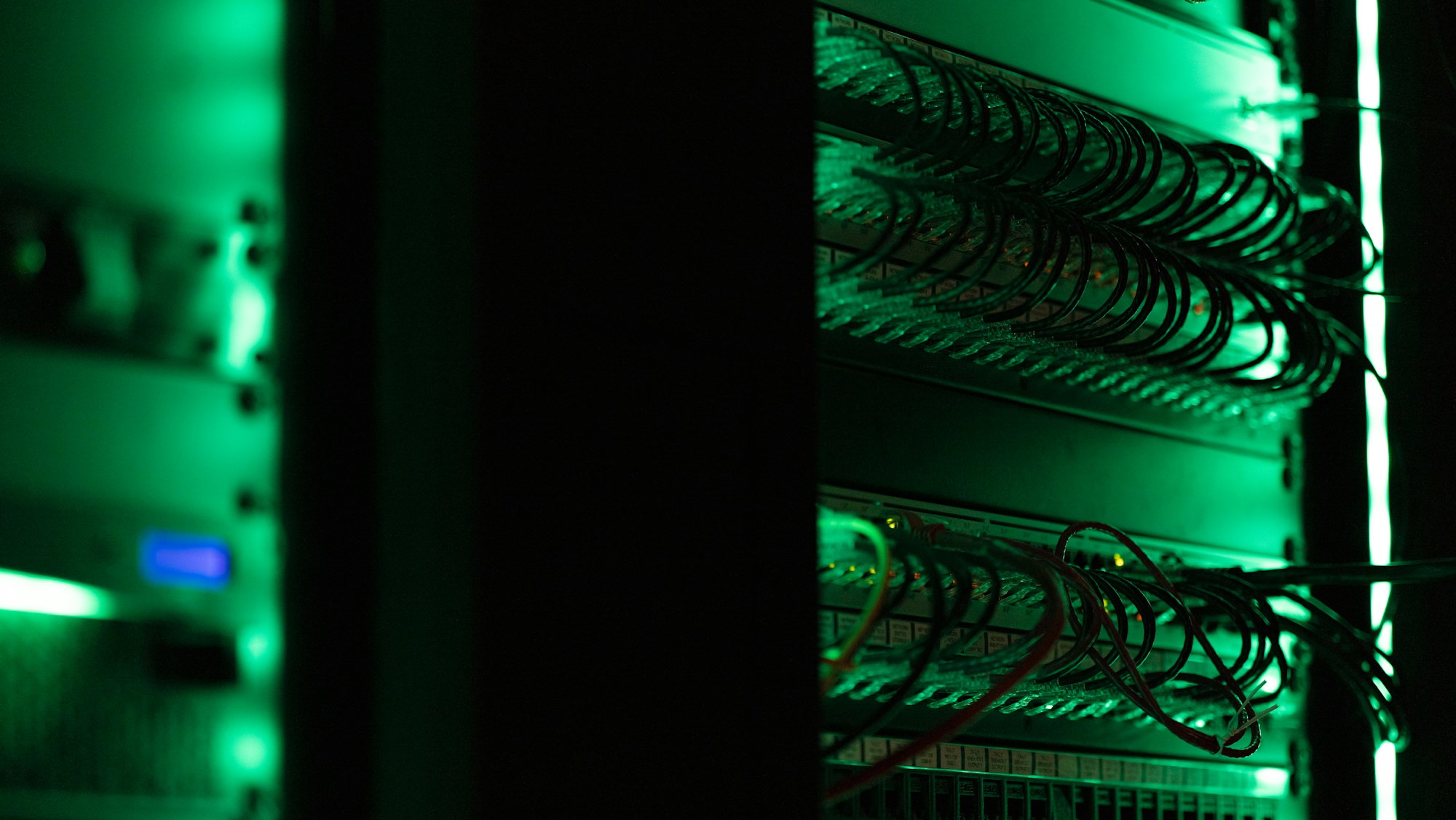 a rack of electronic equipment in a dark room